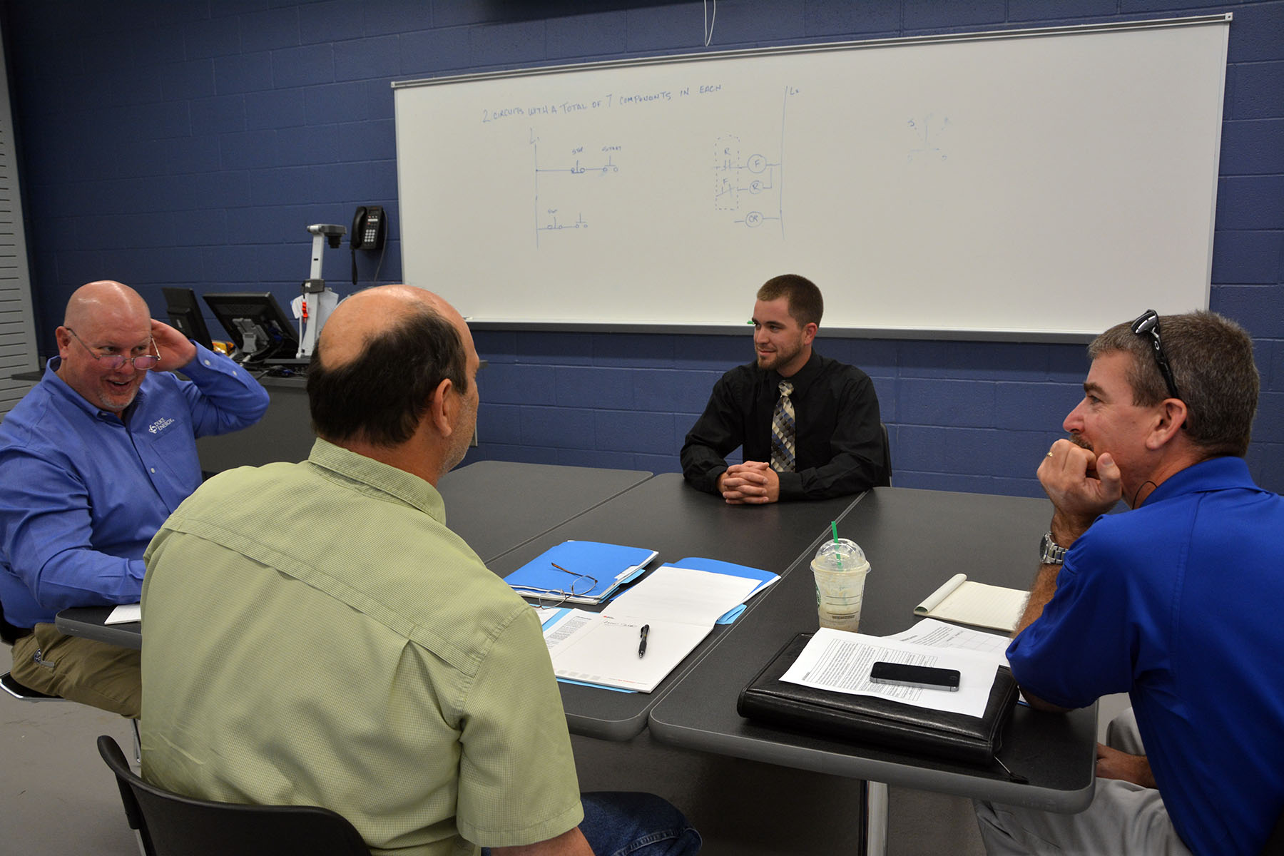 Richmond Community College student Aaron Snead of Rockingham sits in front of a panel of Duke Energy supervisors who interviewed him, along with other Electric Utility Substation and Relay Technology students at RCC, for summer internship spots.