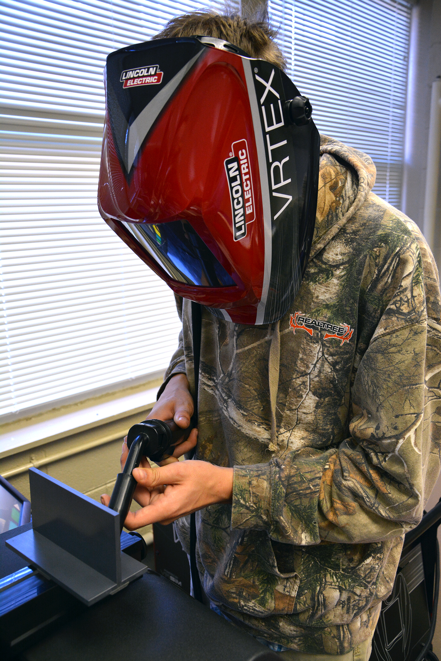 Jeremy Rainwater, a senior in the welding class offered through Richmond Community College at Ashley Chapel Educational Center, hones his cutting skills using a virtual welding machine.