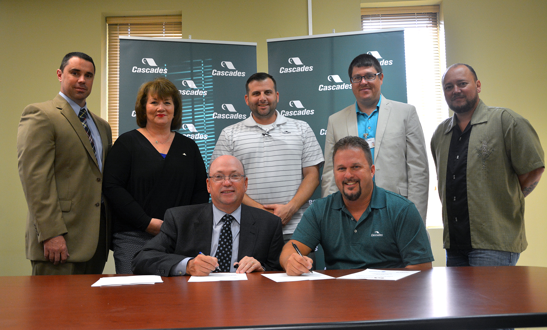 Seated left, Dr. Dale McInnis, president of Richmond Community College, signs a contract alongside Cascades Tissue Rockingham Mill Manager Mickey Lee, securing state-funded customized training for the company's employees through RichmondCC. Also pictured, standing in back, from left, are Dr. Robbie Taylor, vice president of Workforce and Economic Development at RichmondCC; Cascades Human Resource Manager Debbie Currie; Cascades Production Manager Mario Infante; RichmondCC Director of Customized Training Lee Eller; and Cascades Maintenance Manager Jake Elder. 