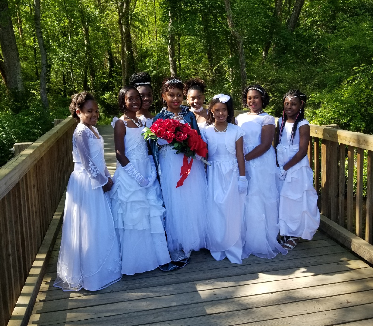 The Cinderella Girls stand in a group on a bridge for a photo