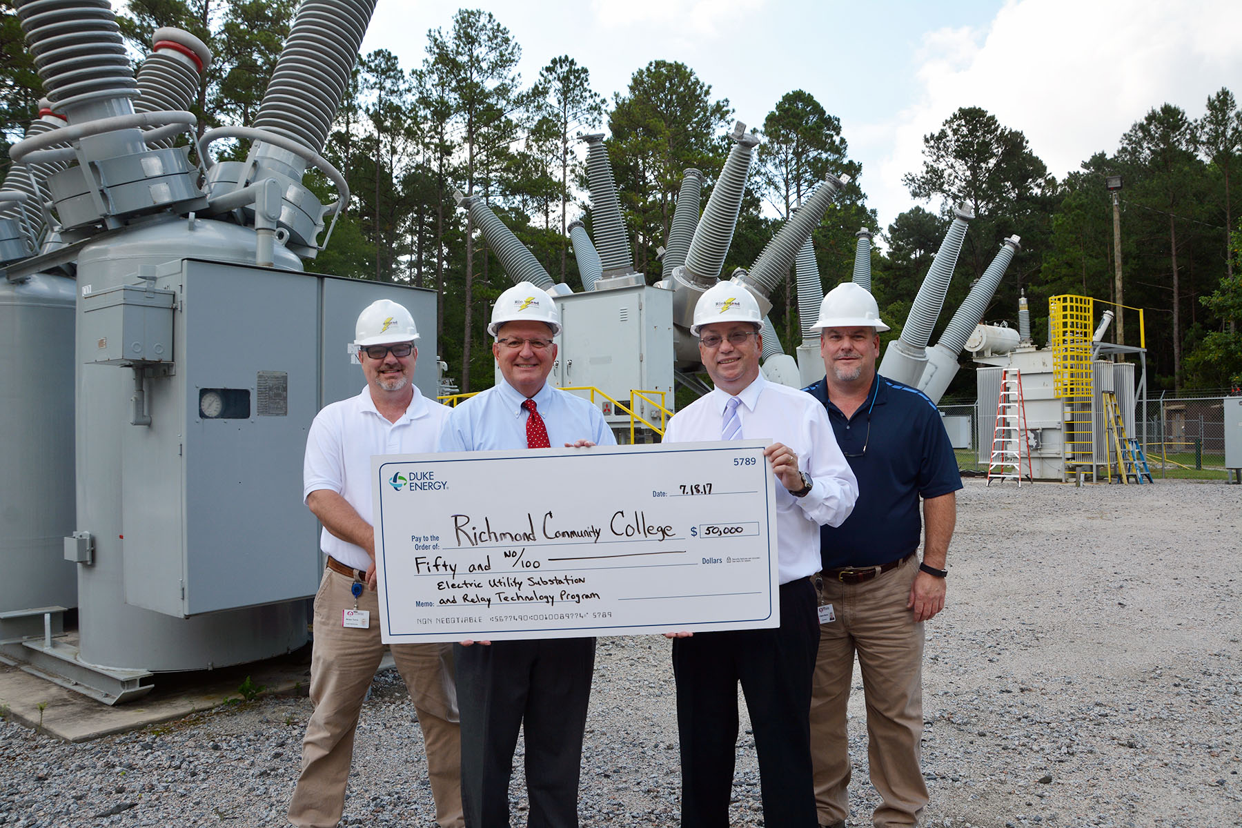Duke Energy's David McNeill presents a check for $50,000 to the College to support the substation program.