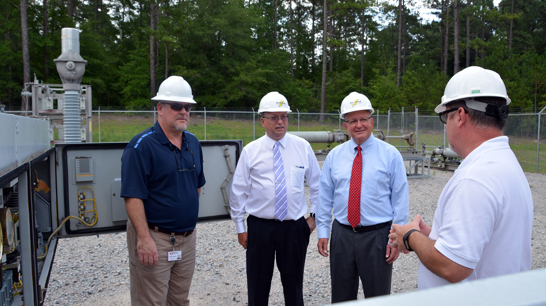 College president Dr. Dale McInnis and Duke Energy's David McNeill talk with faculty about equipment in the substation.