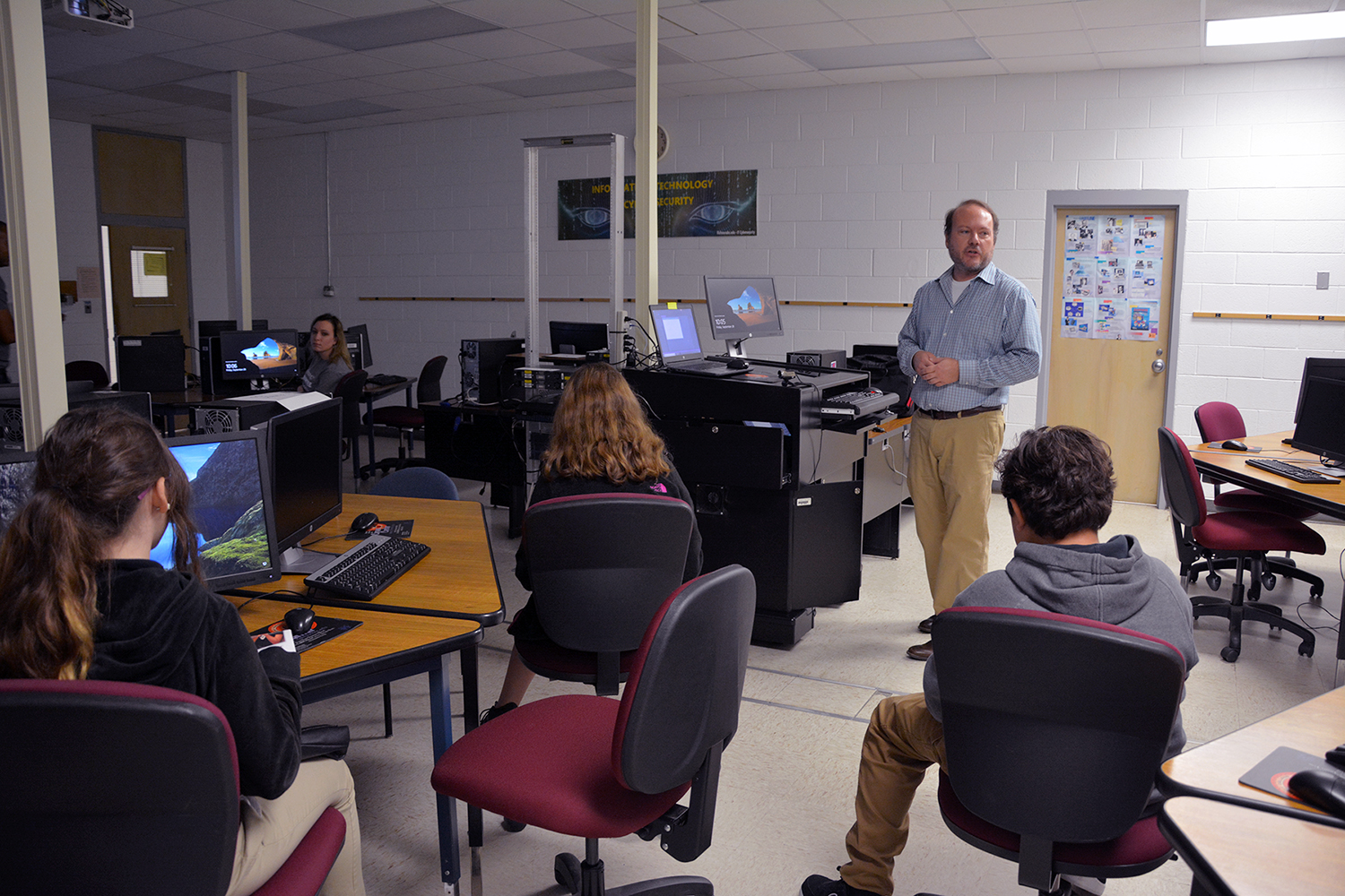 IT instructor talking to students in classroom