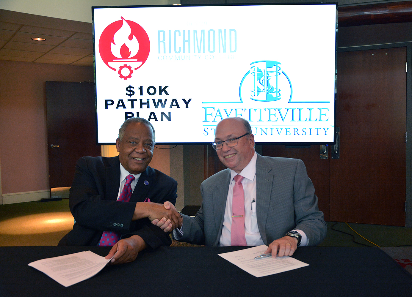Chancellor Anderson and Dr. McInnis shakes hands after signing the agreement for the $10K Degree Pathway Plan
