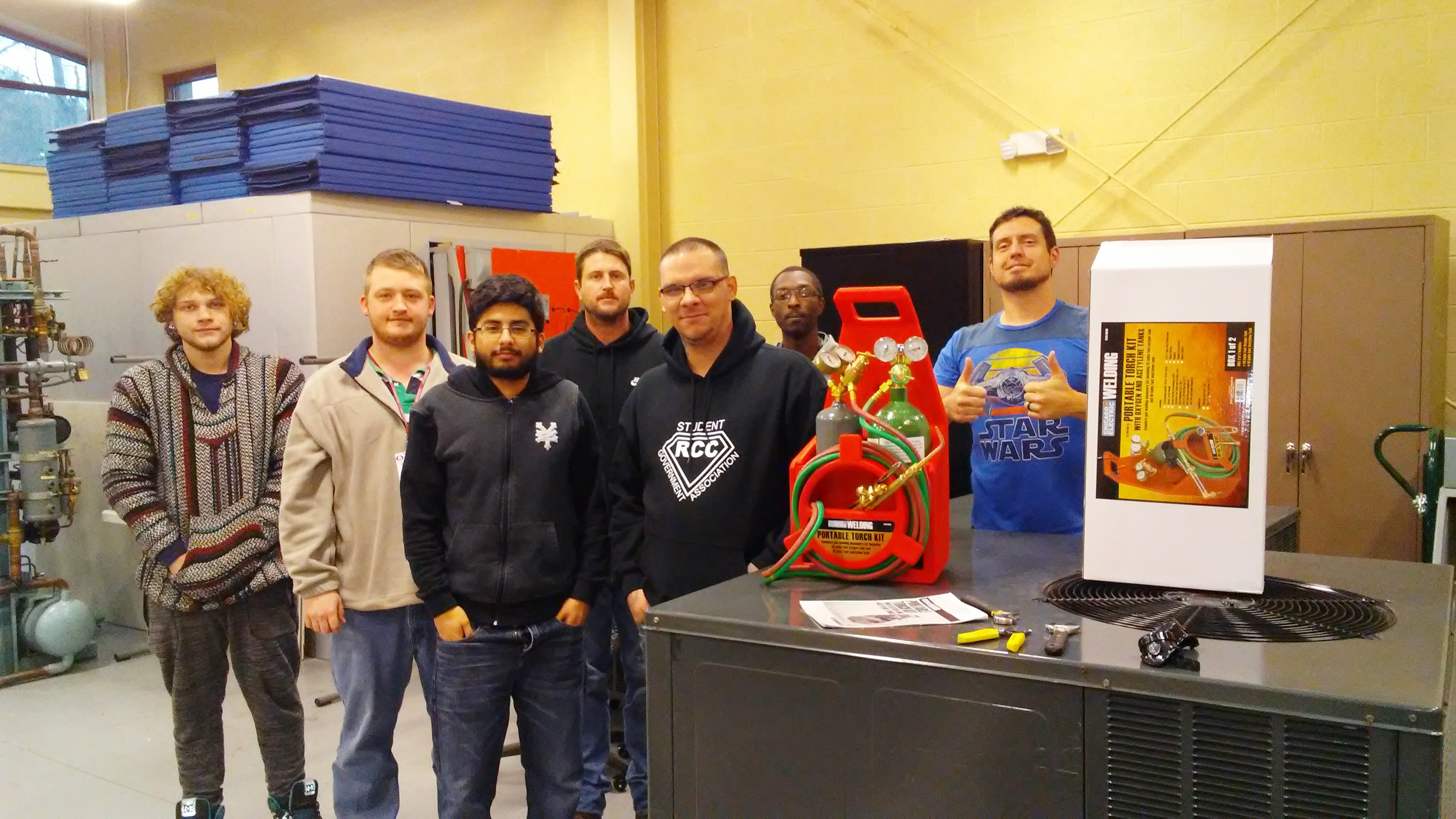 HVACR students holding torch donation from Harbor Freight 