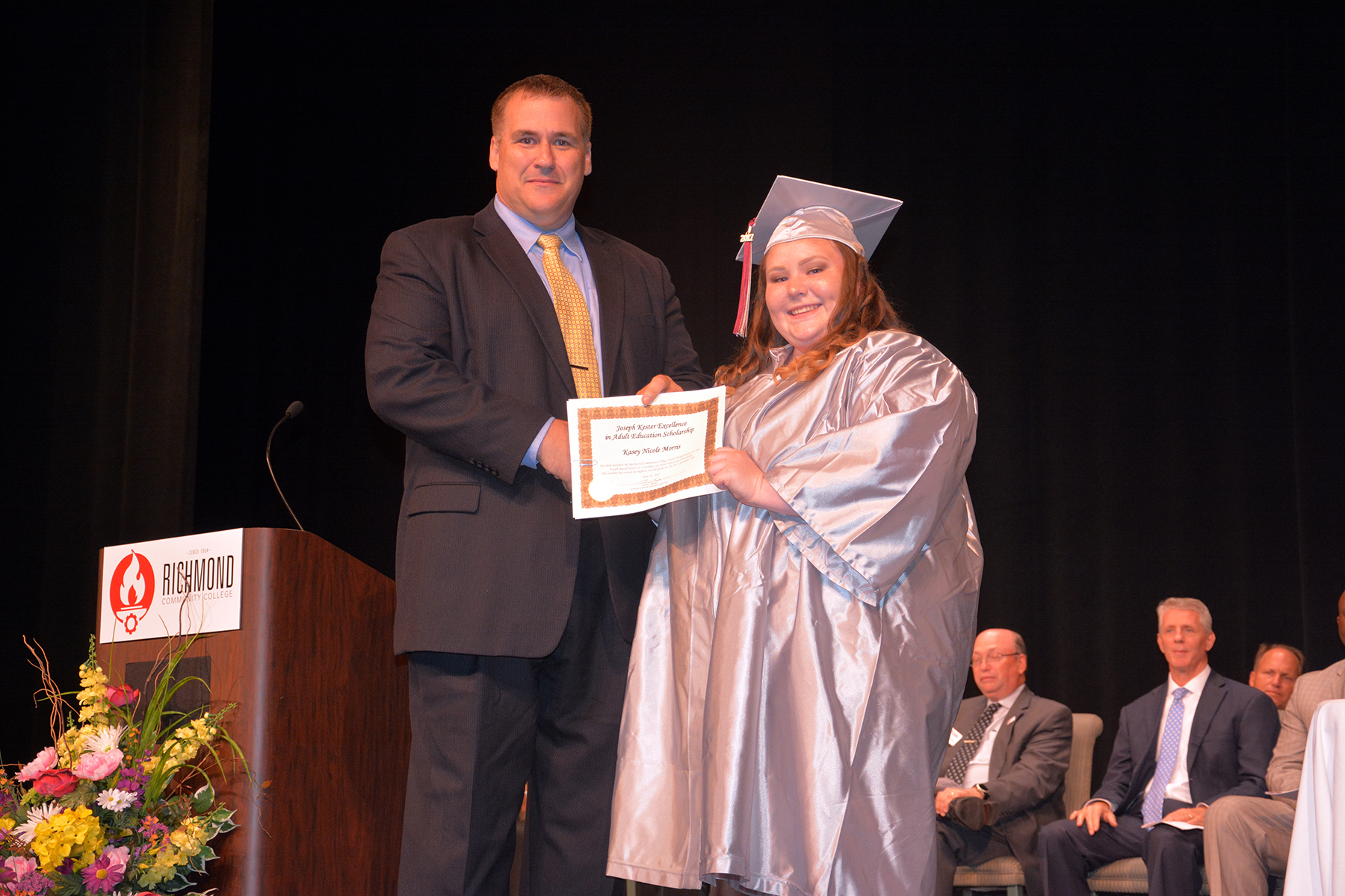 Pictured is Adult High School graduate Kasey Morris receiving the Joseph R. Kester Excellence in Education Scholarship from Richmond Community College Director of Adult Education John Kester.