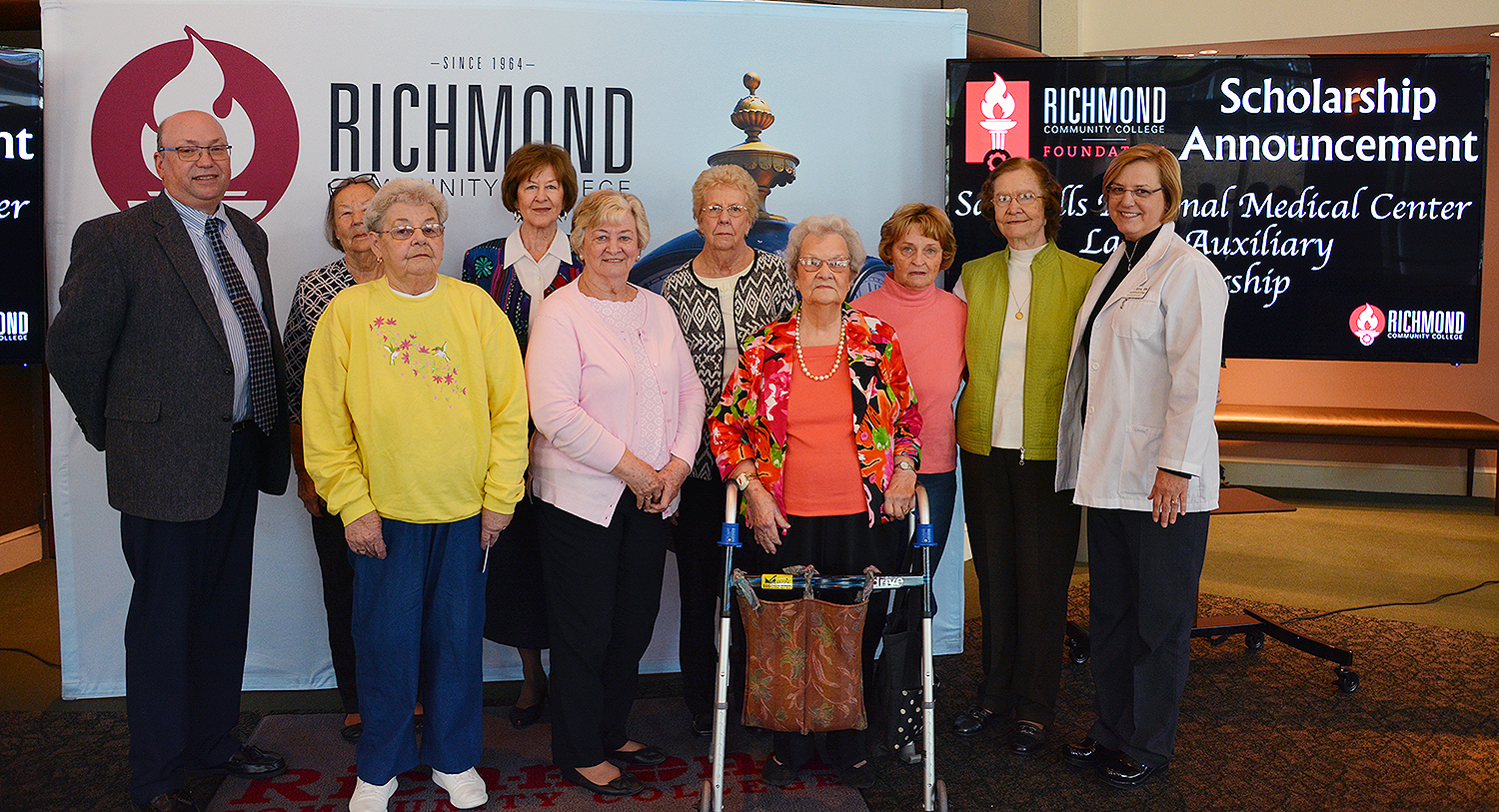 The Ladies Auxiliary group stands with Dr. McInnis and Janet Sims.