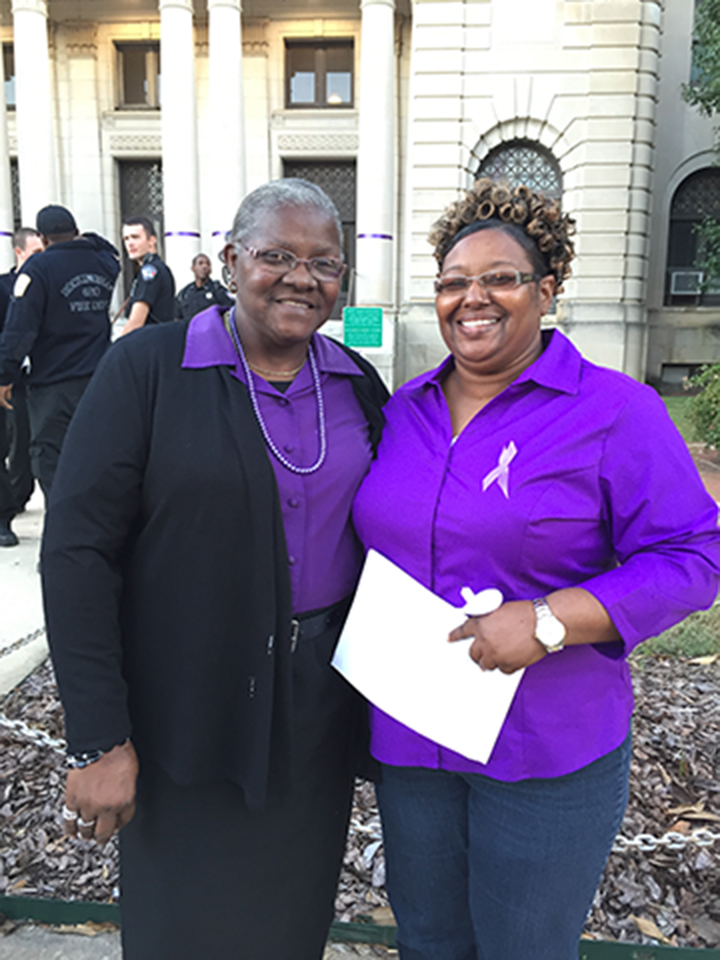 RCC employees stand in front of the courthouse where they took part in a domestic violence vigil
