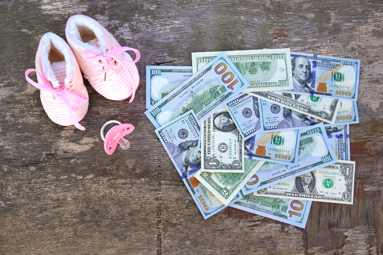 Photo of baby booties and cash