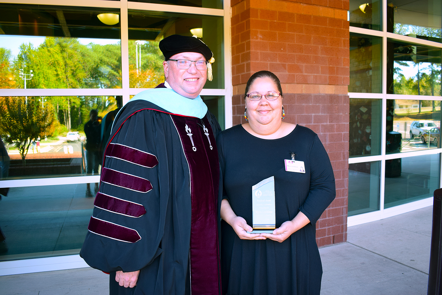 Dr. Dale McInnis stands with Myra Locklear, who is holding her President's Award.