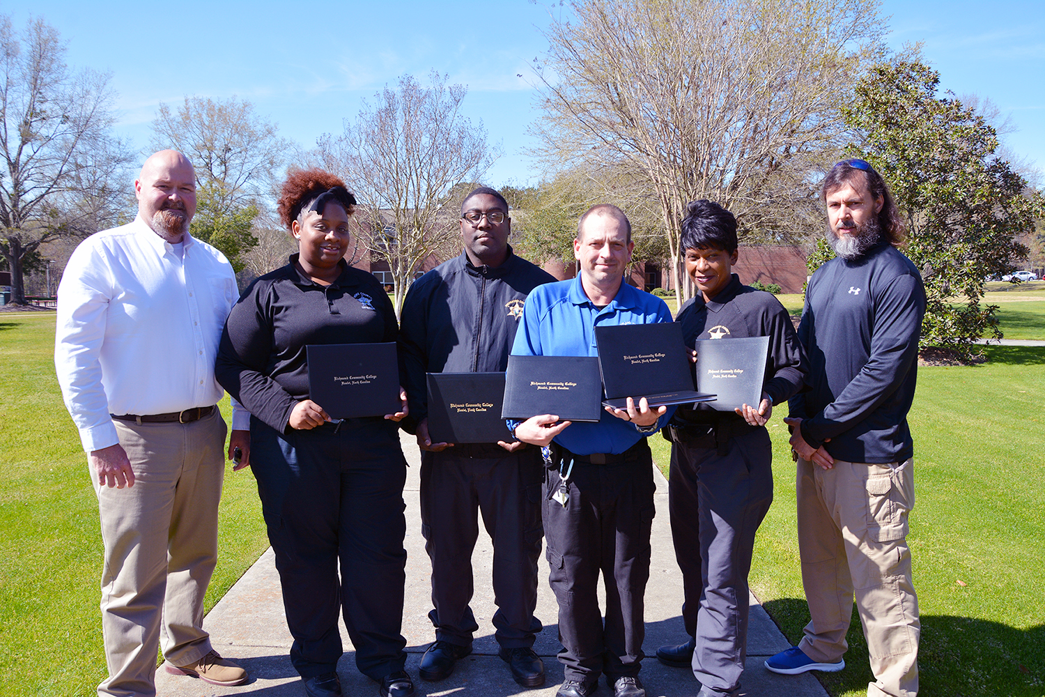 Students completing the Detention Officer Certification course stand in a group for a photo.