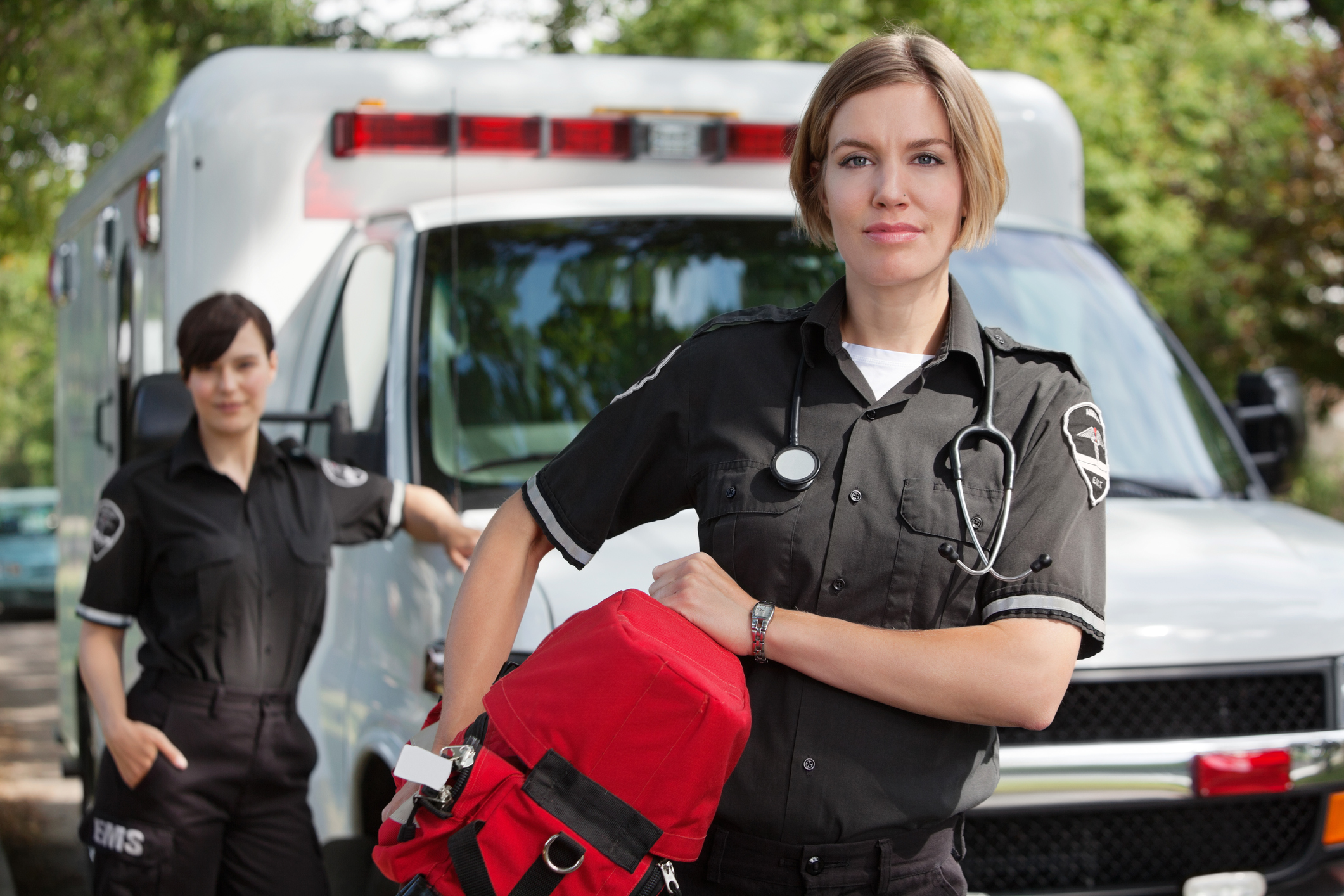 EMS personnel standing by ambulance