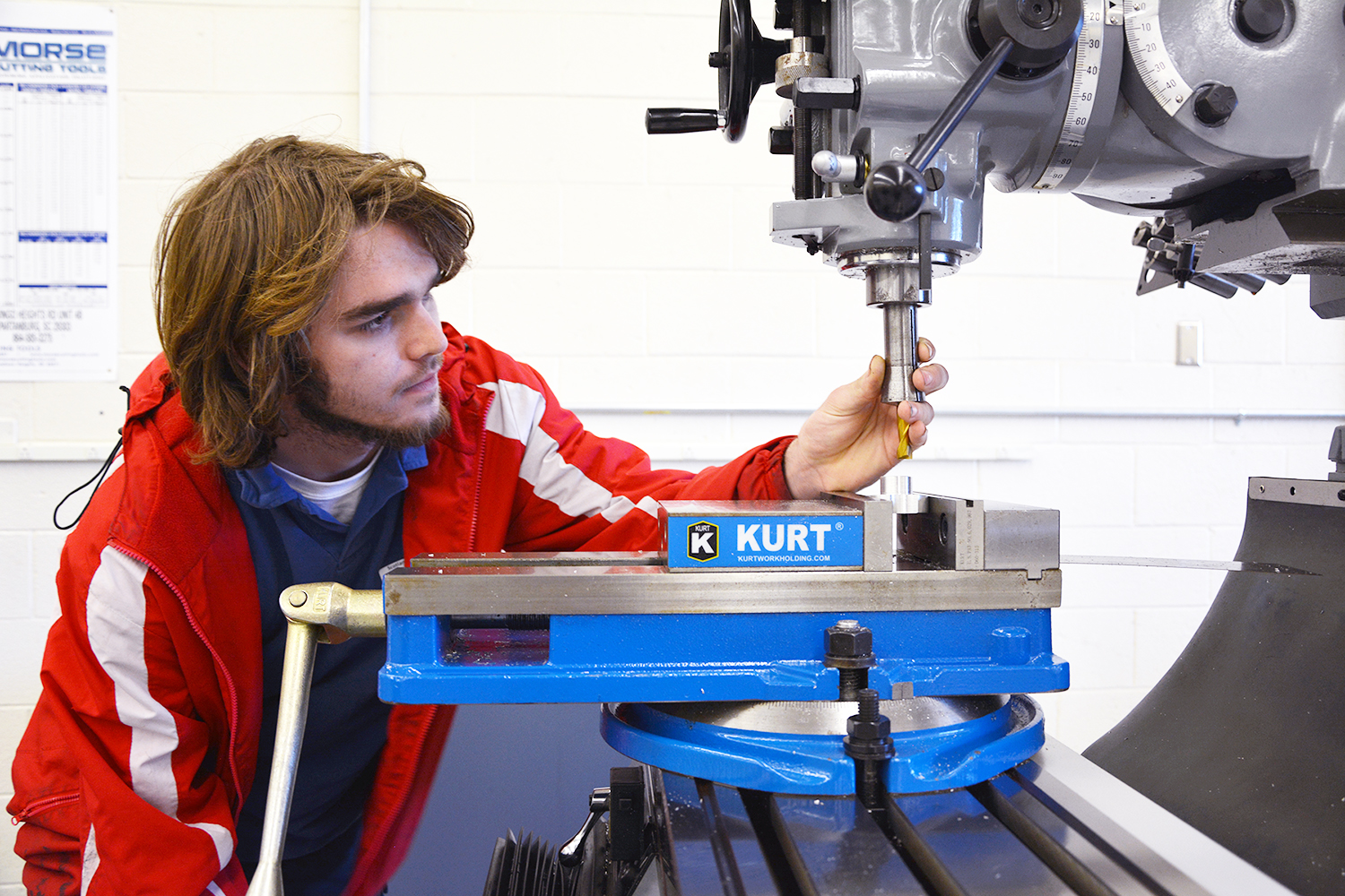 Computer-Integrated Machining student works on a press