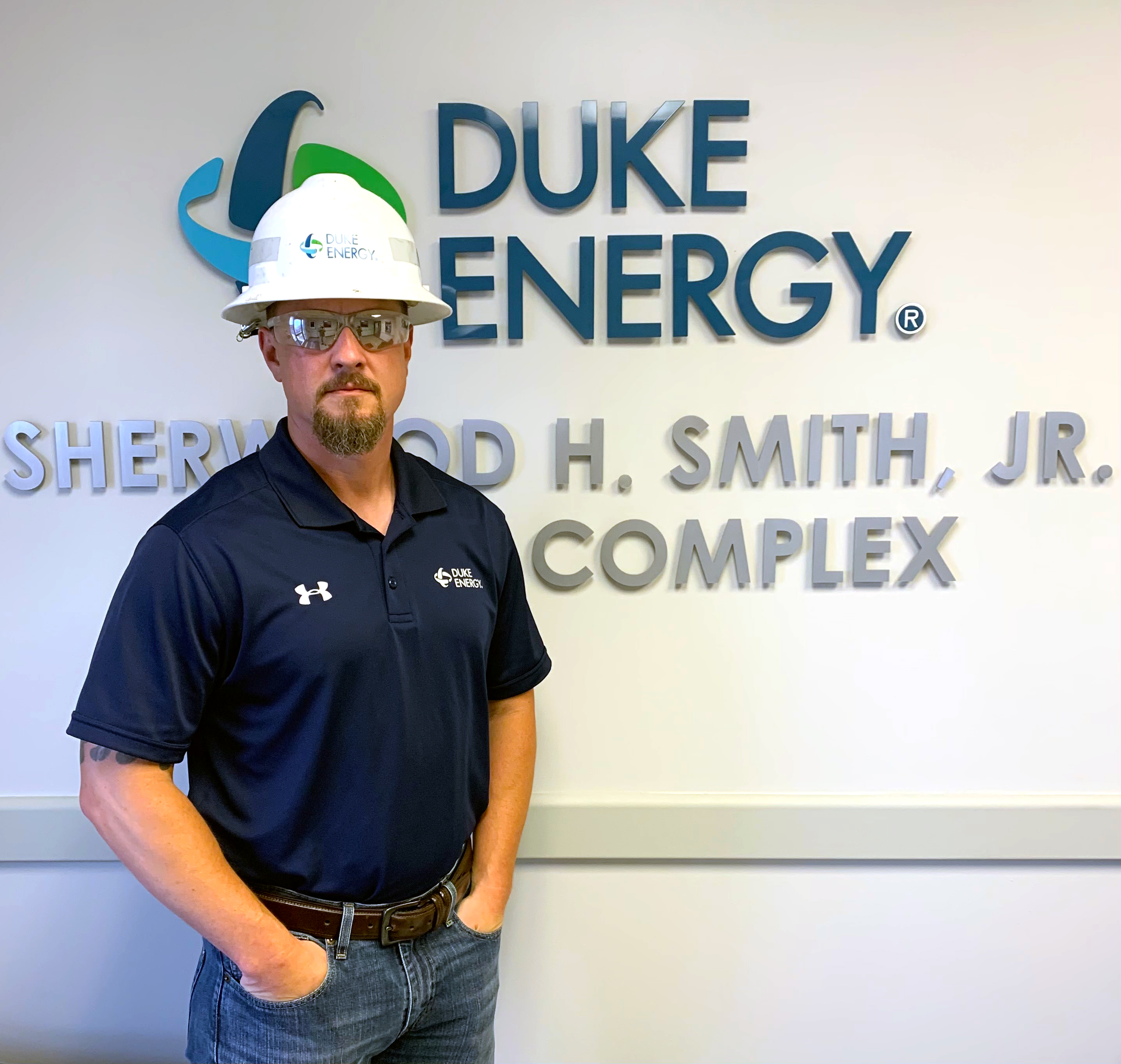 Matthew Wood standing in front of Duke Energy sign