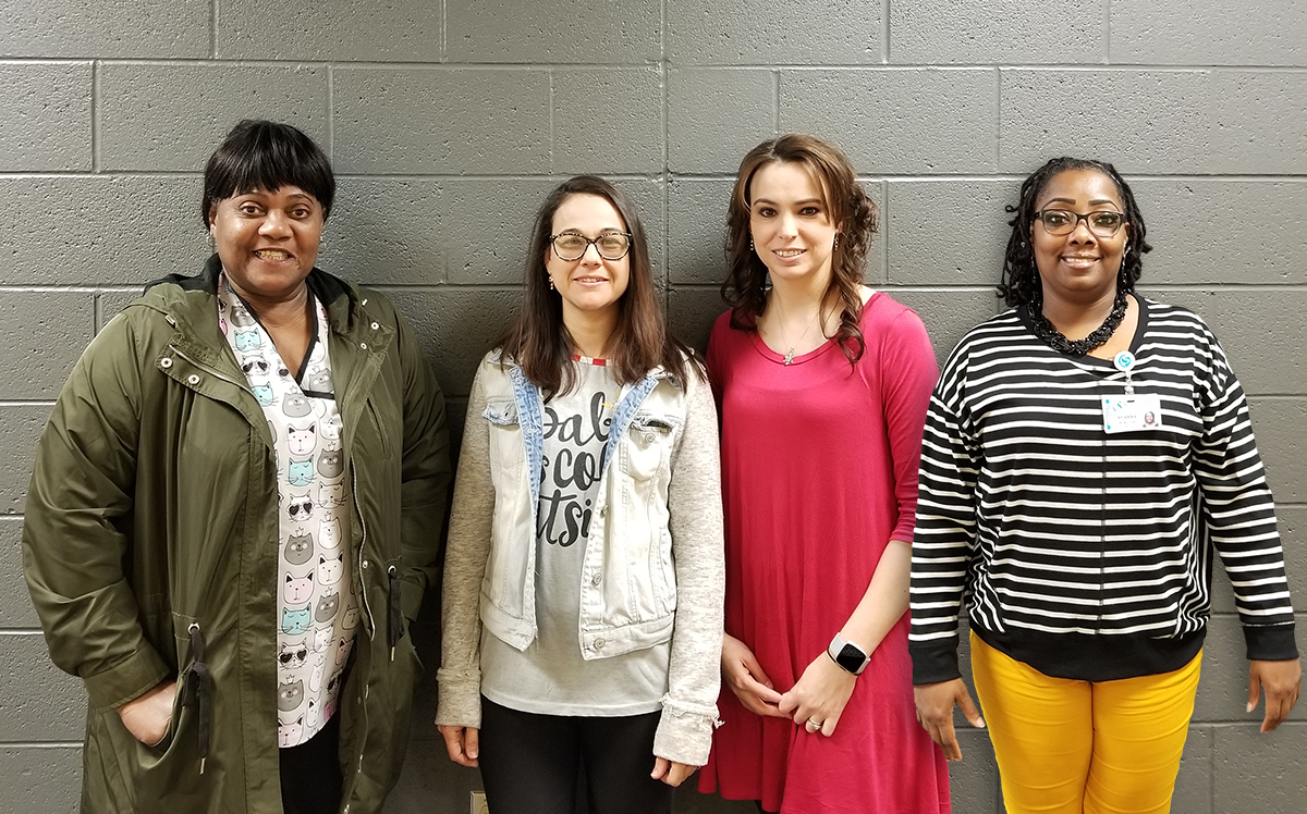 Four students who passed the Medical Administrative Assistant certification exam pose for a picture.