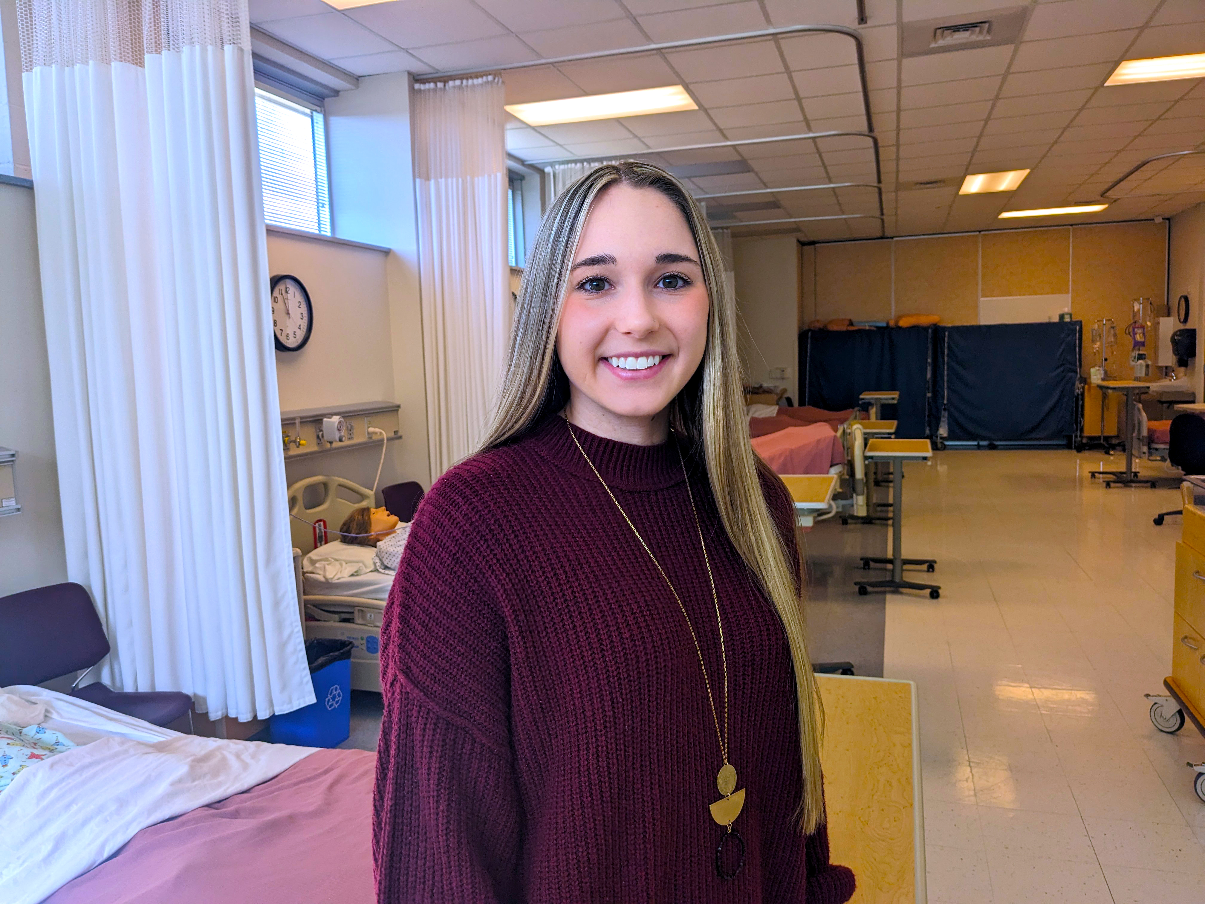 Payton Chappell stands in nursing lab.