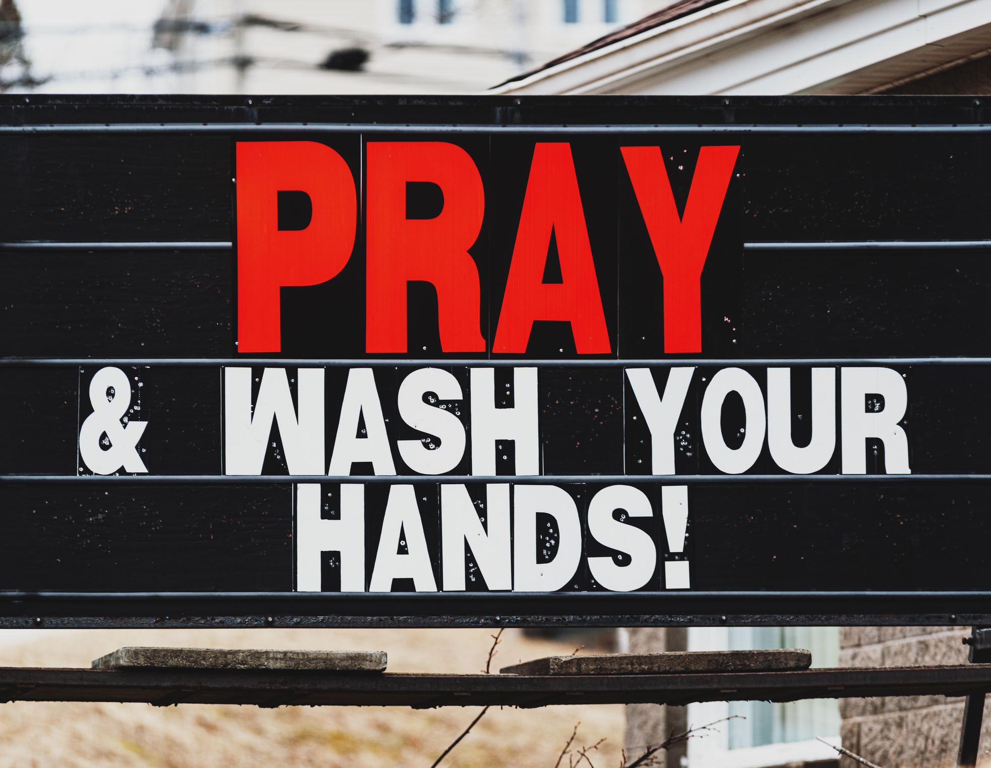 Sign for churches being open with message to wash hands