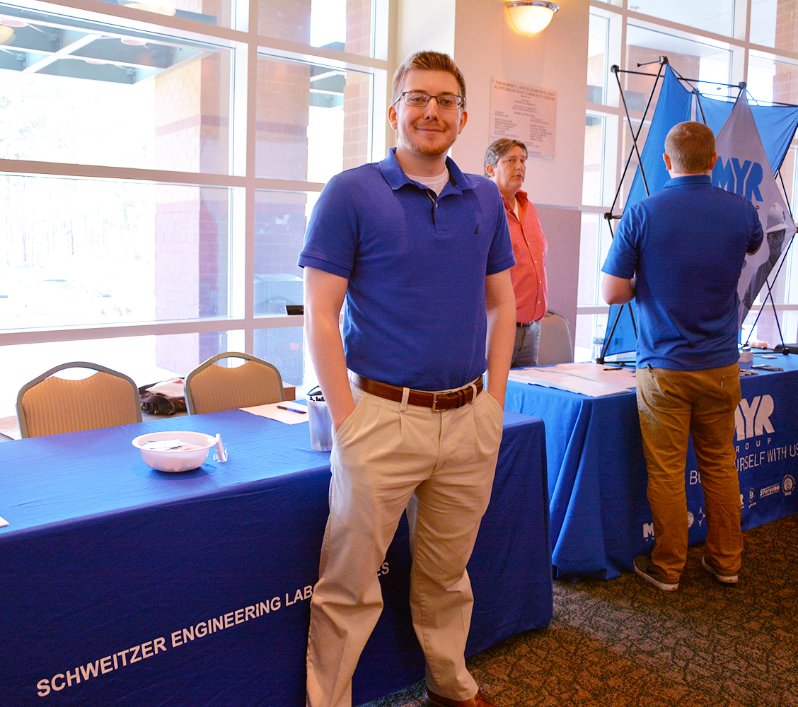 Substation graduate Sandy Guinn stands by the SEL table at the Power the World Career Fair.