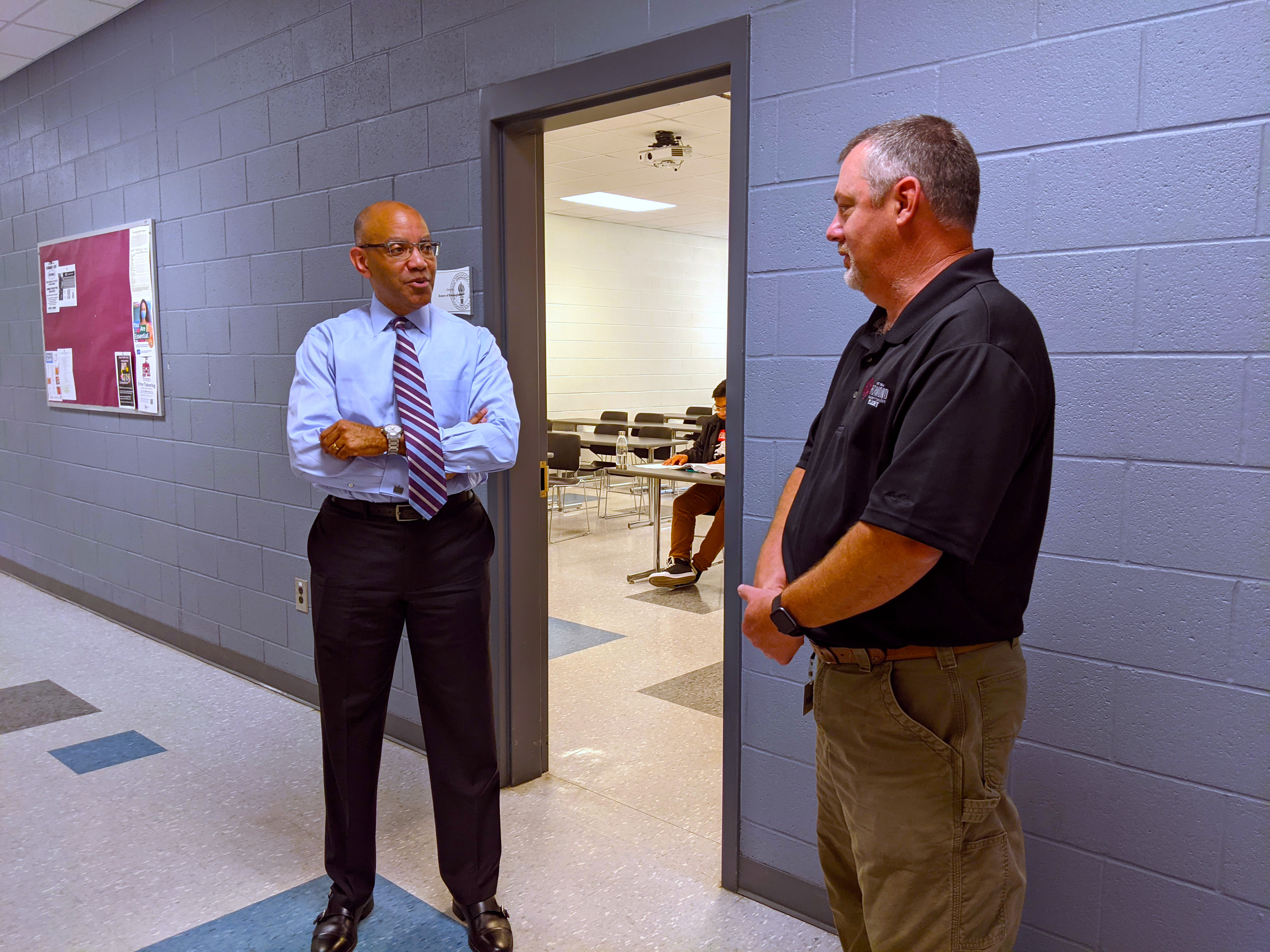 President Stith talks to a RichmondCC instructor in a hallway