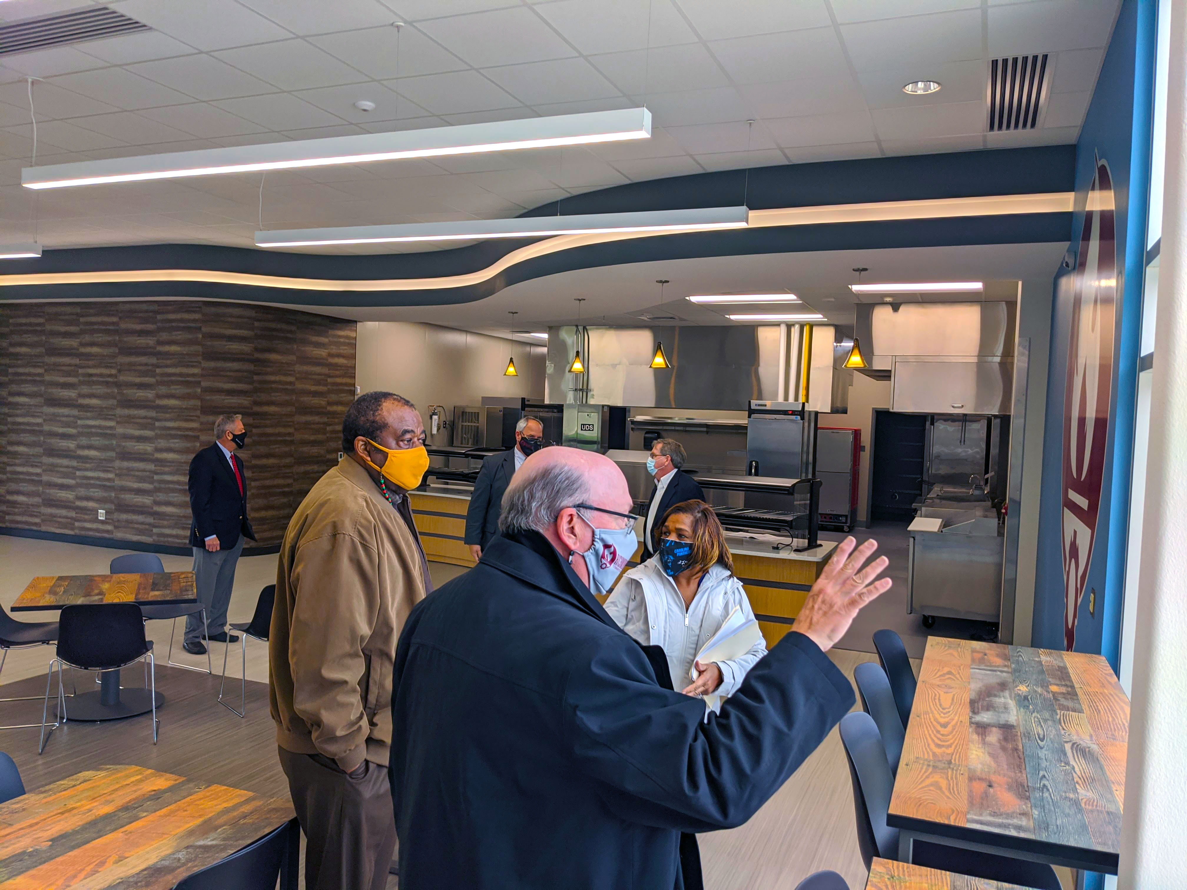 College President and Board of Trustees tour the student cafe
