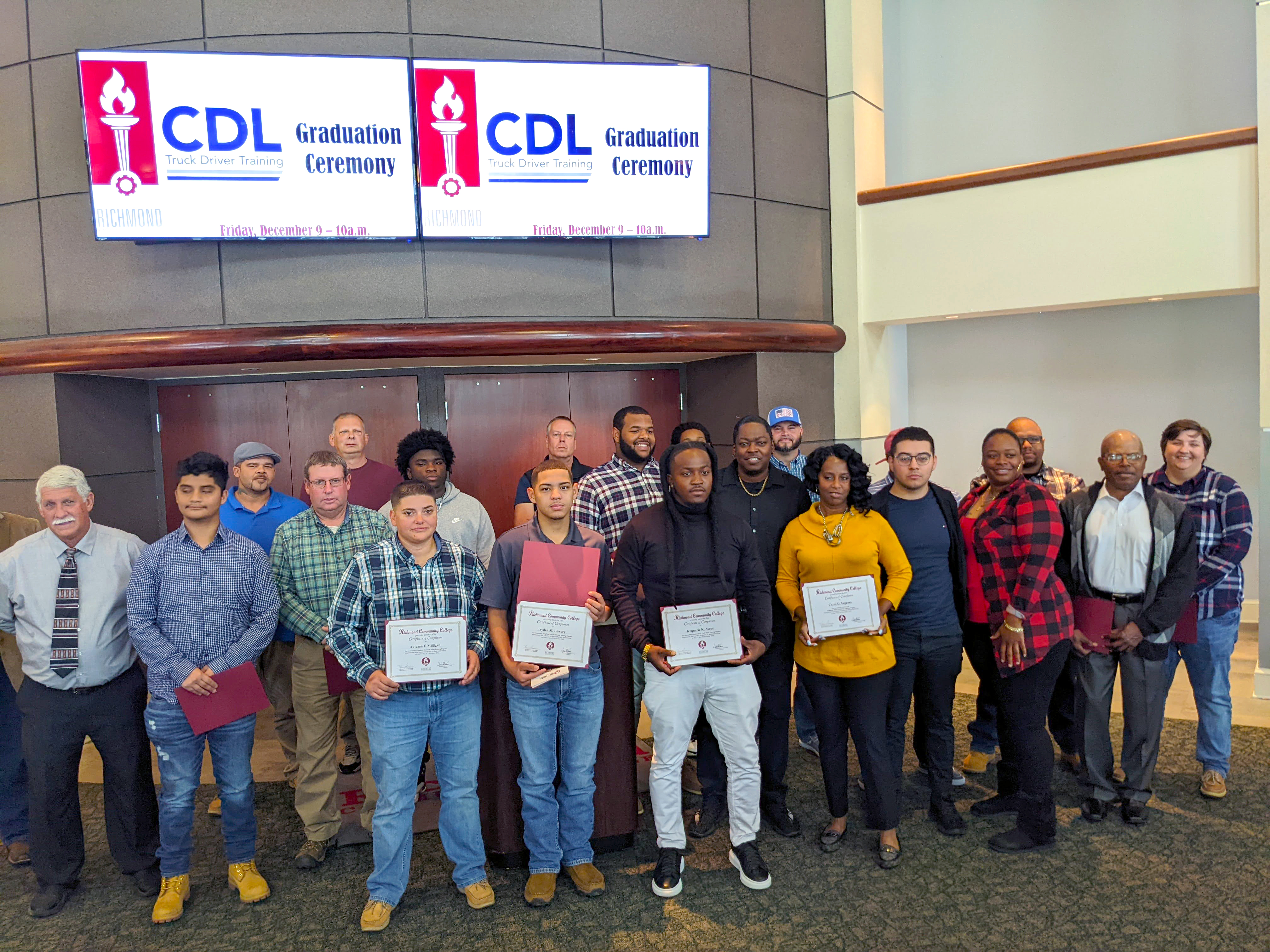 Truck Driver Training graduates stand with their instructors