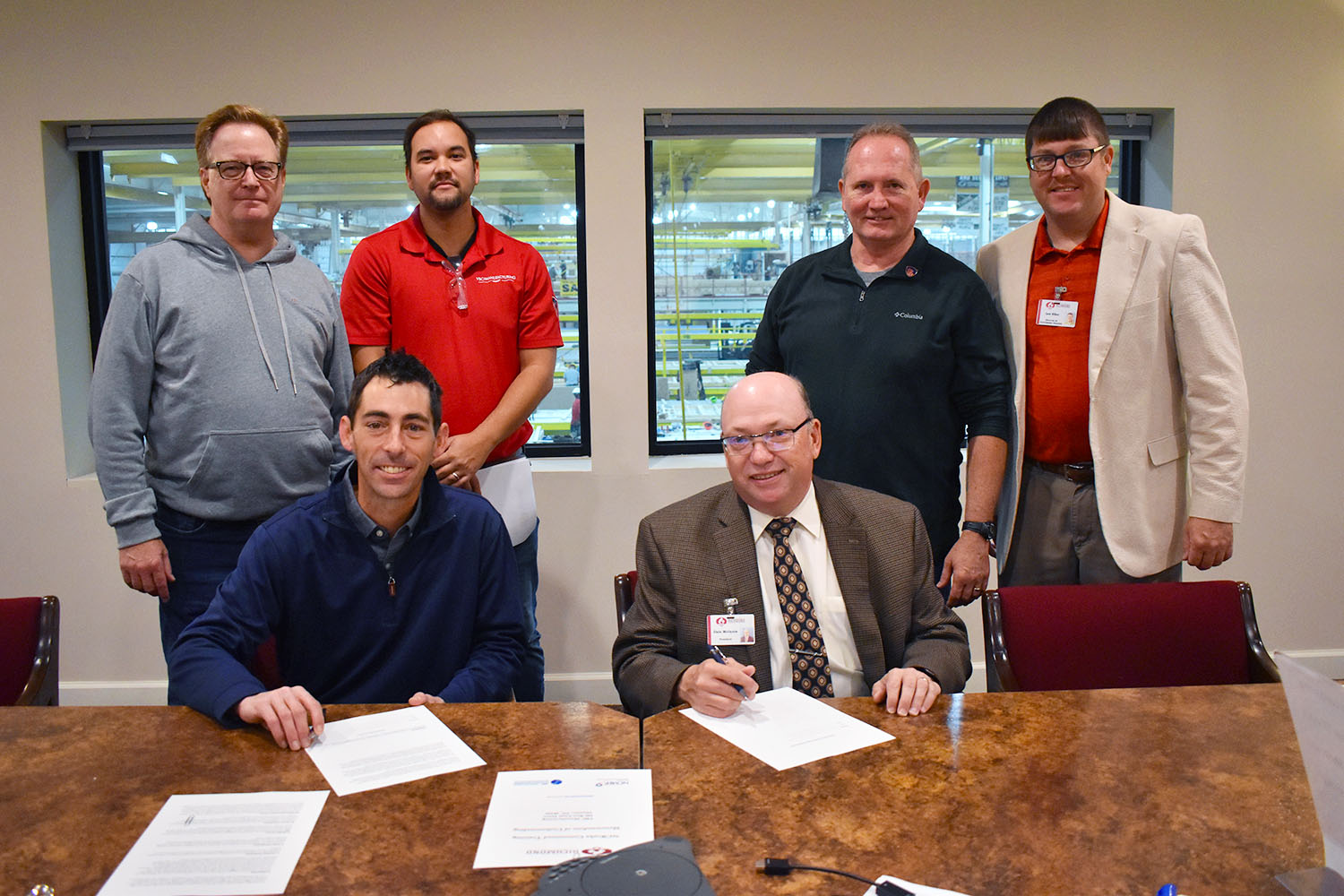 College leaders and upper management for VBC | Manufacturing sign a contract for training.