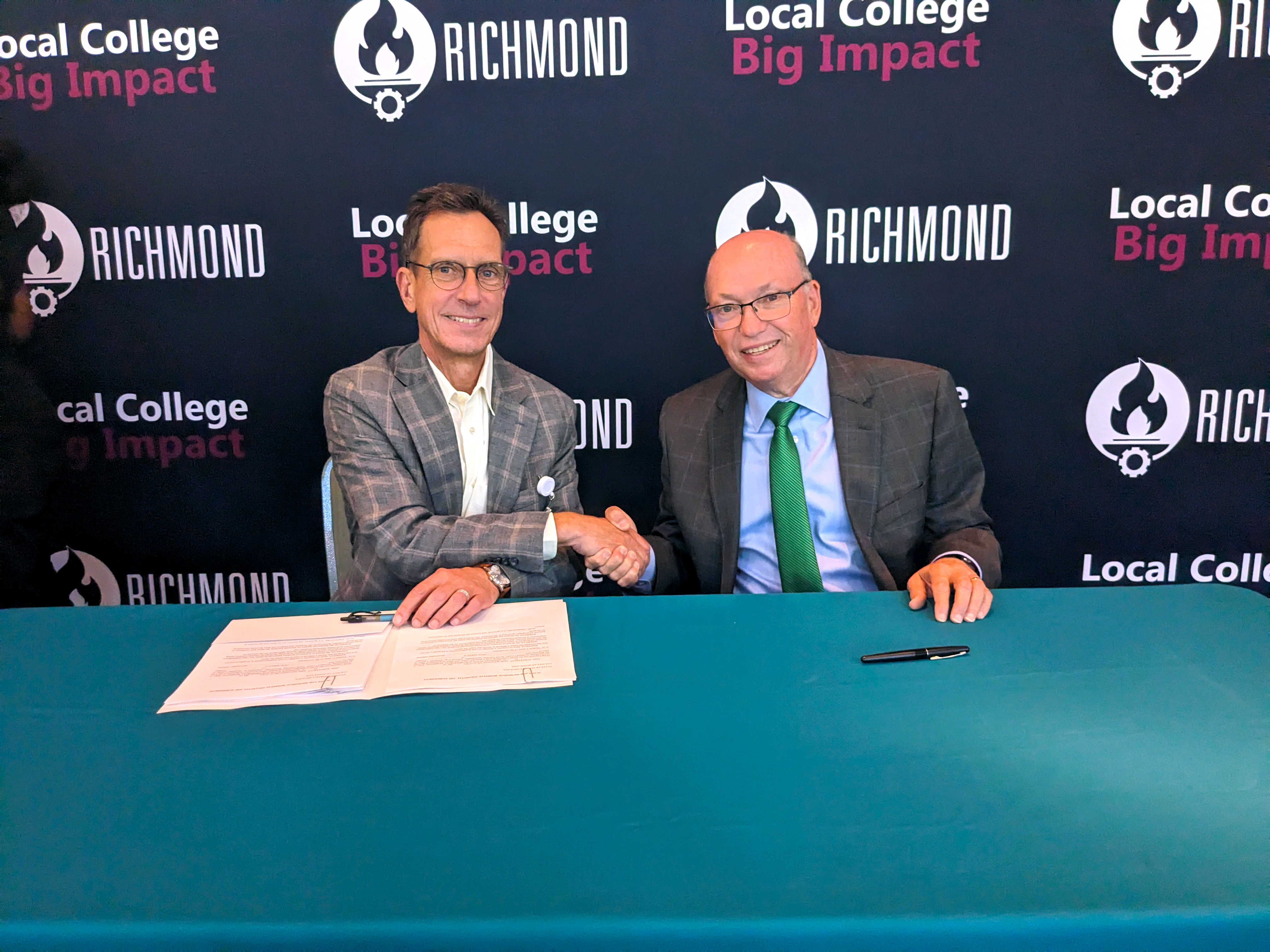 Scotland Health Care CEO Gregory Wood and Dr. Dale McInnis, president of RichmondCC, shake hands.