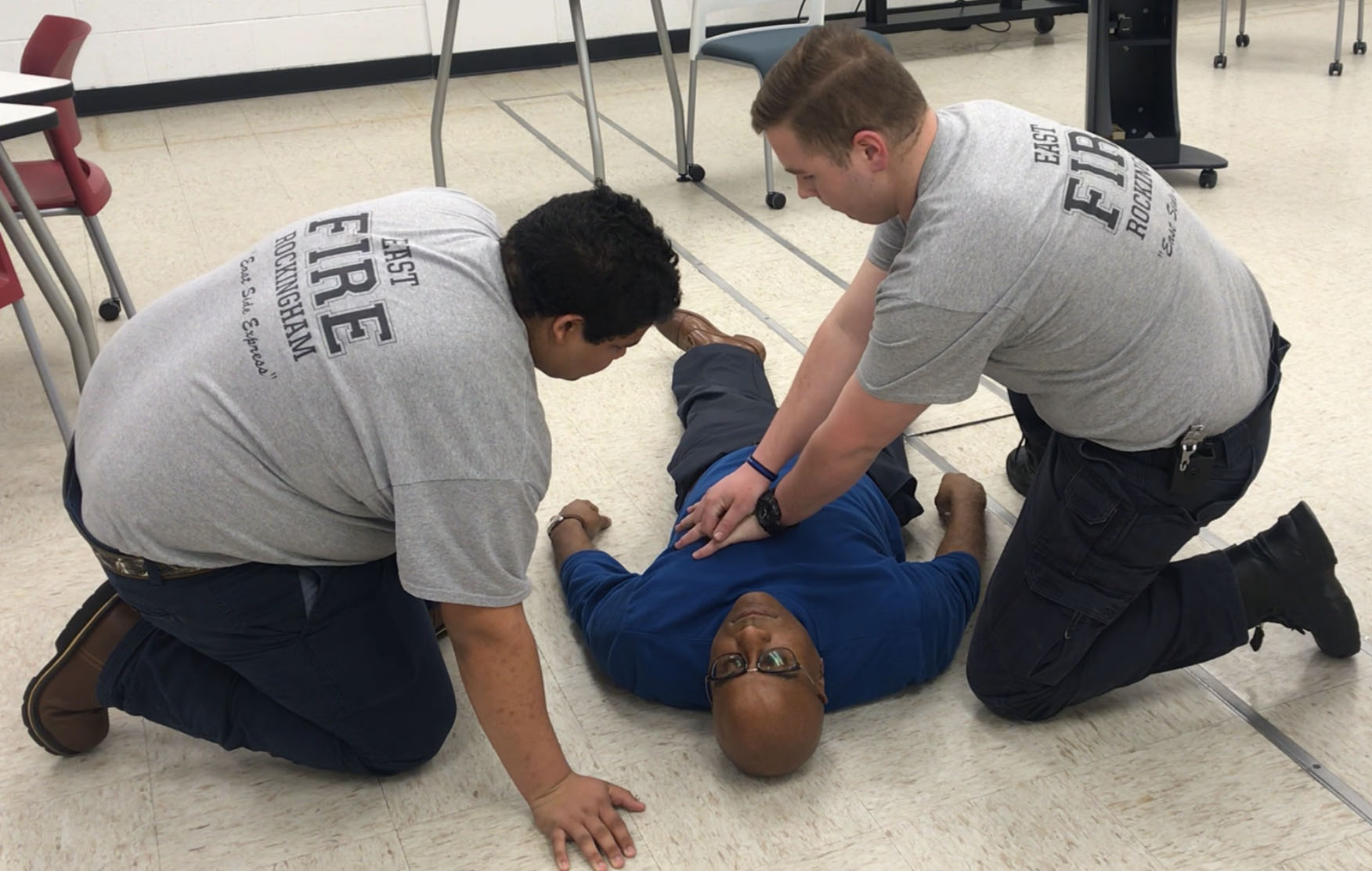 East Rockingham Fire Dept. Junior Firefighters, Kendell Watson and Marcus Bethea administrating emergency care on patient.