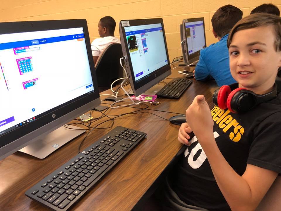Student giving the thumbs up in a summer STEM camp