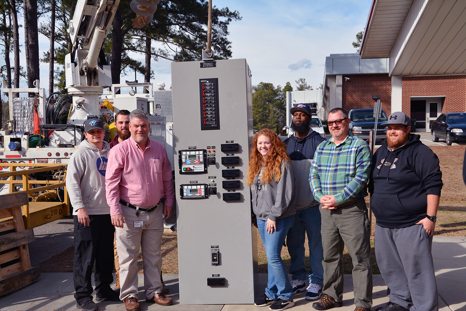 EUSRT Students and instructors with donated relay panel in substation