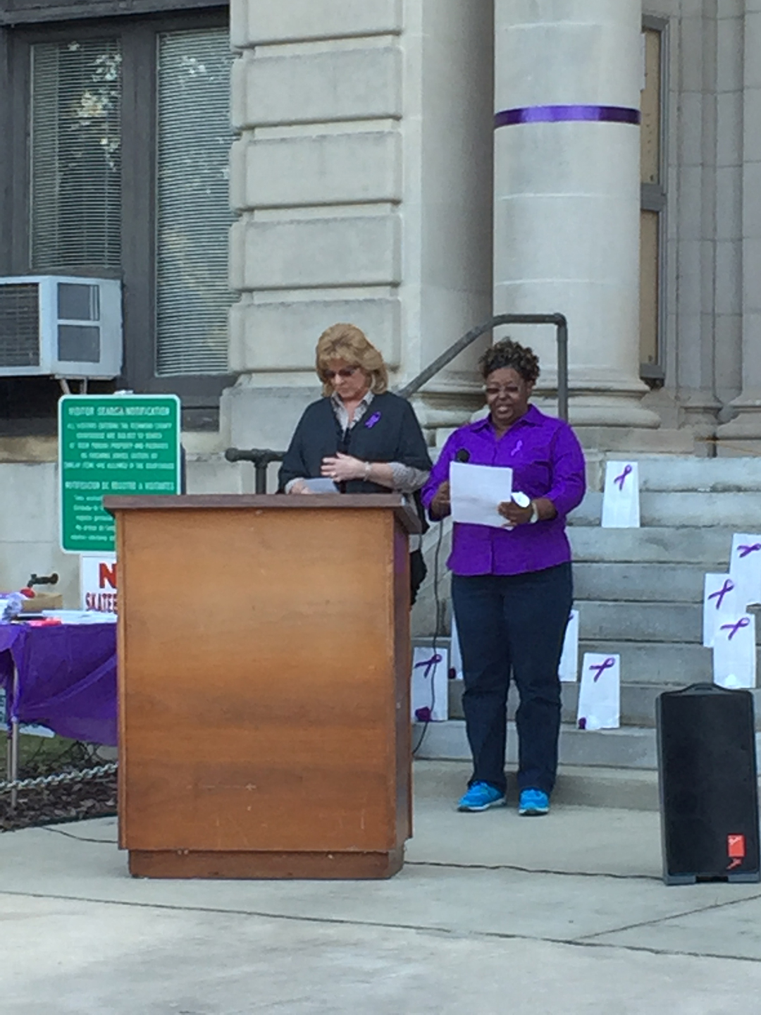 Salley Ingram reads a poem on the steps of the courthouse.