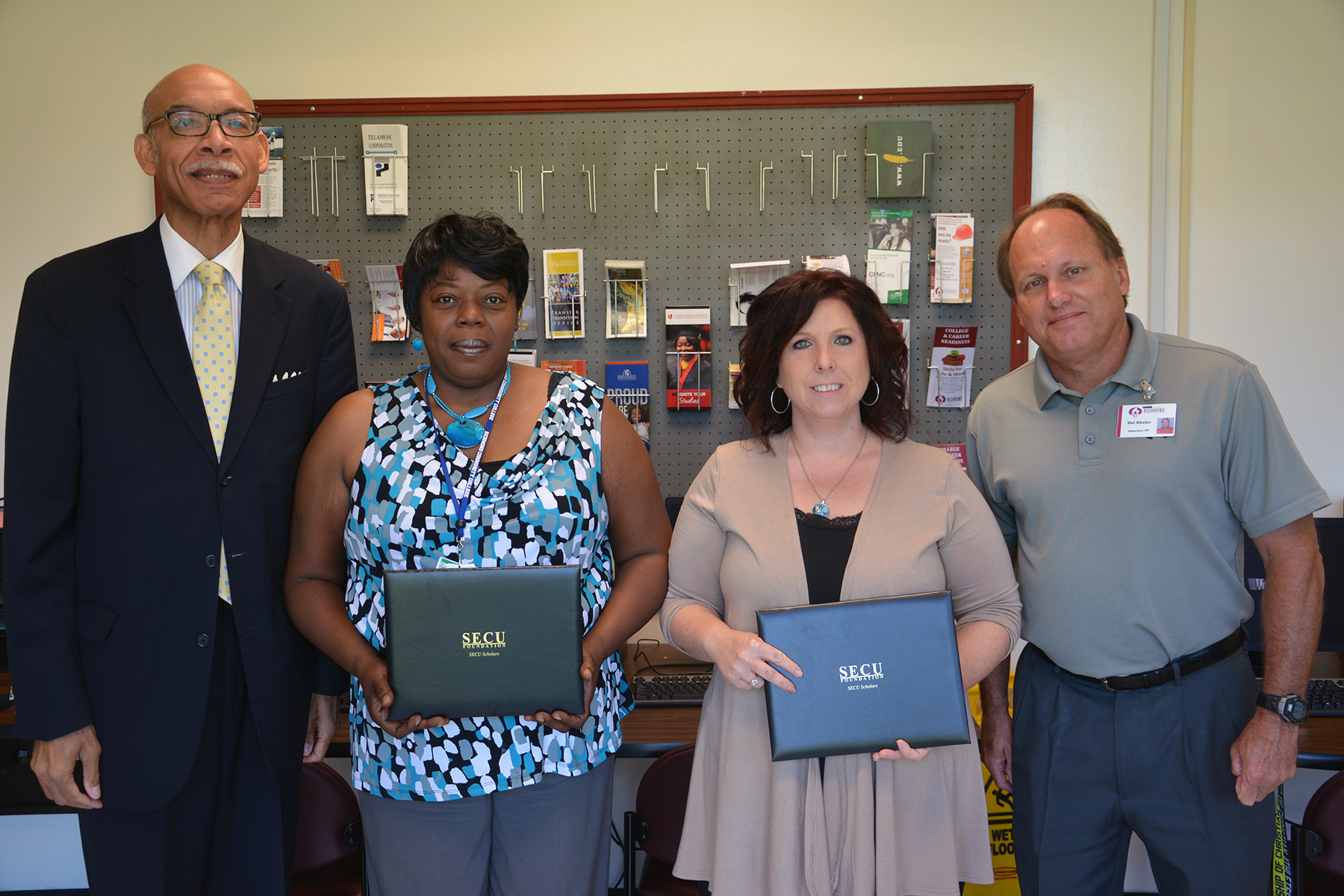 From left, State Employees Credit Union Vice President City Executive Douglas M. Fulford Jr. stands with People Helping People Scholarship recipients Gyvonna Bowman and Nancy McIntyre and Associate Vice President for Development Dr. Hal Shuler at Richmond Community College.