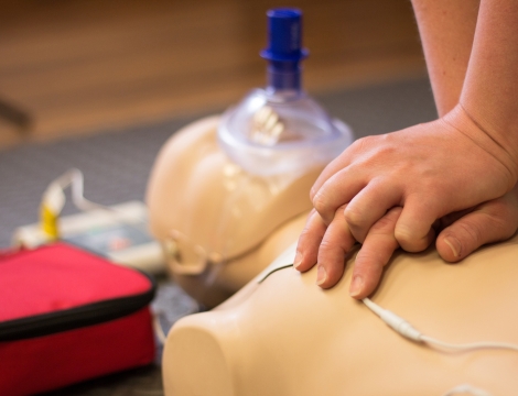 CPR compressions being done by a person for training