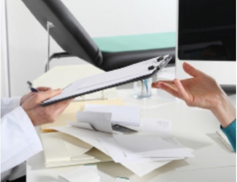 Person handing a clipboard to someone