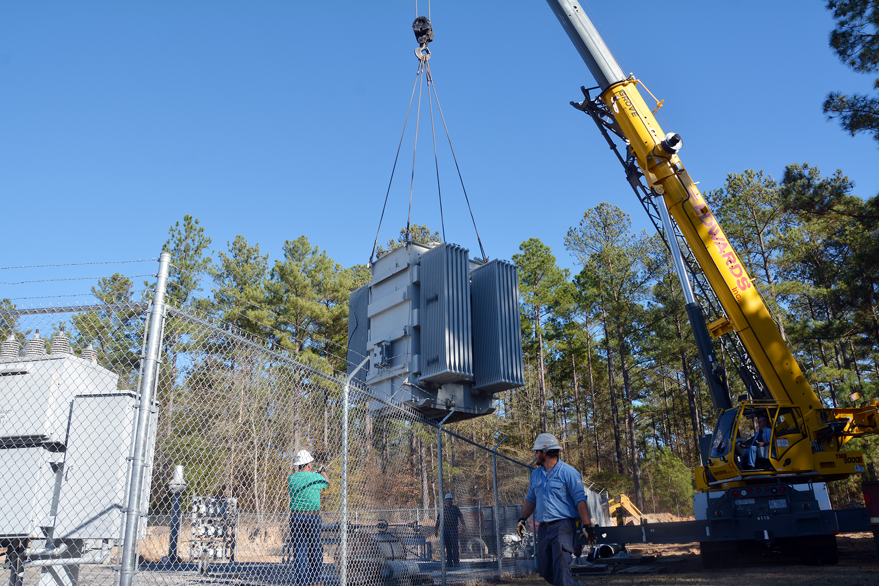 A crew from Duke Energy works with an Edwards Inc. crane operator to install a 115,000-volt transformer into Richmond Community College’s substation. Duke Energy donated the transformer to the College’s Electric Utility Substation and Relay Technology program.