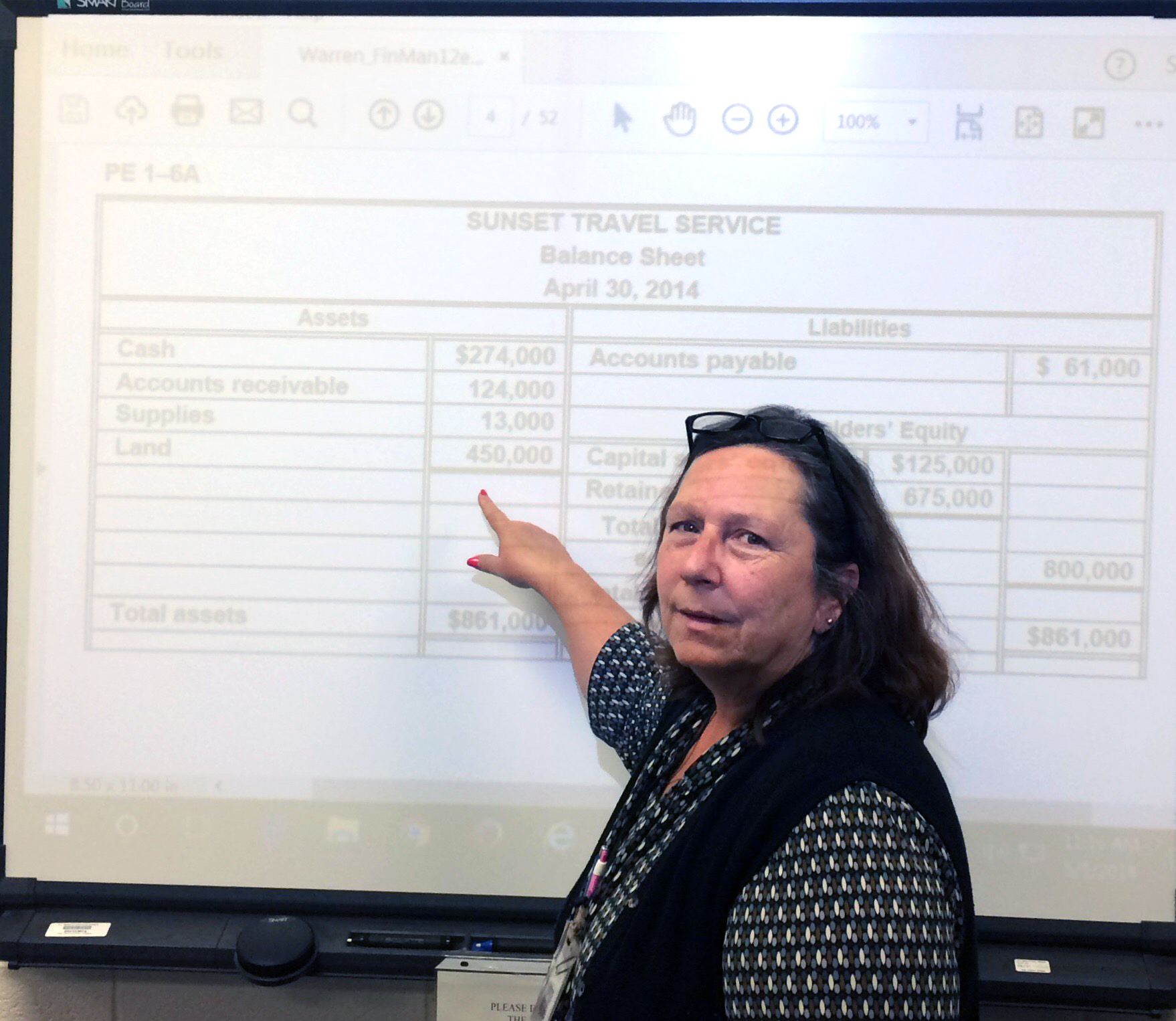 Wendy Pope stands at a white board in her classroom