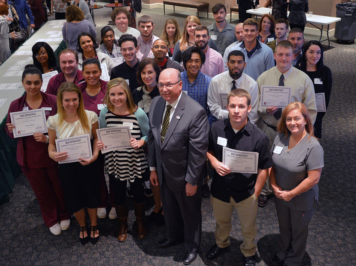 Working Scholarship recipients stand with Dr. Dale McInnis, president of RichmondCC