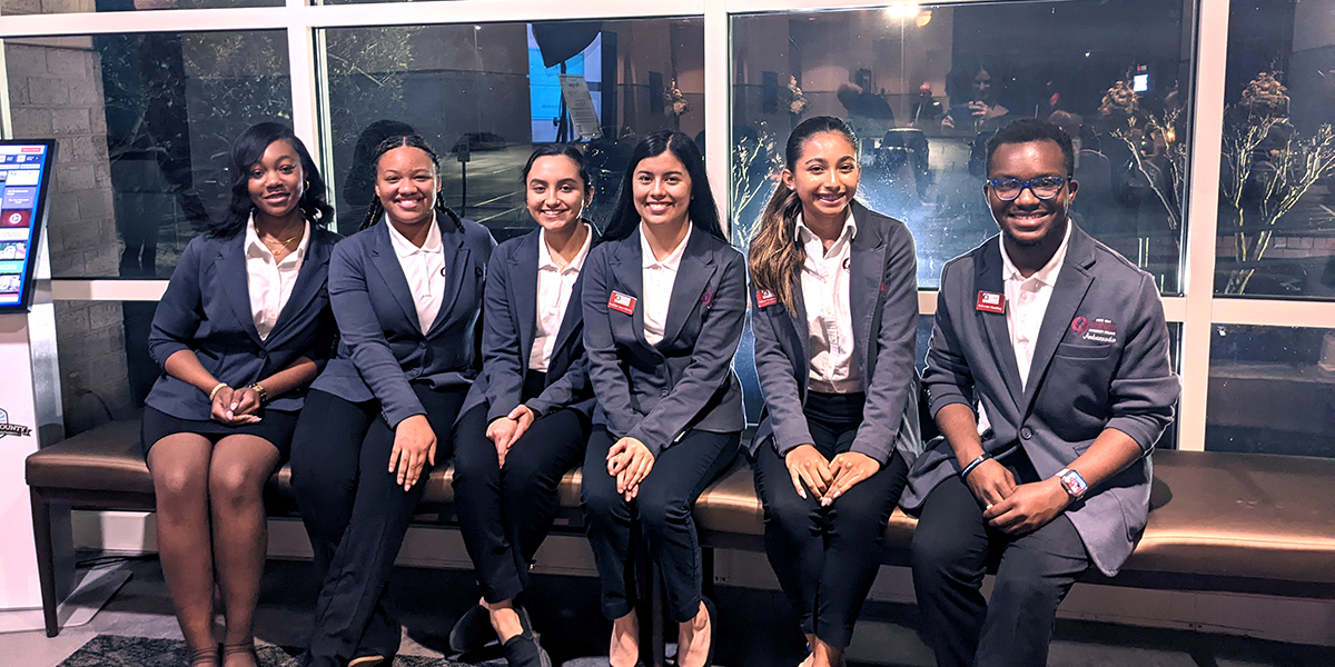 RichmondCC Student Ambassadors sit on a bench in the Cole lobby.