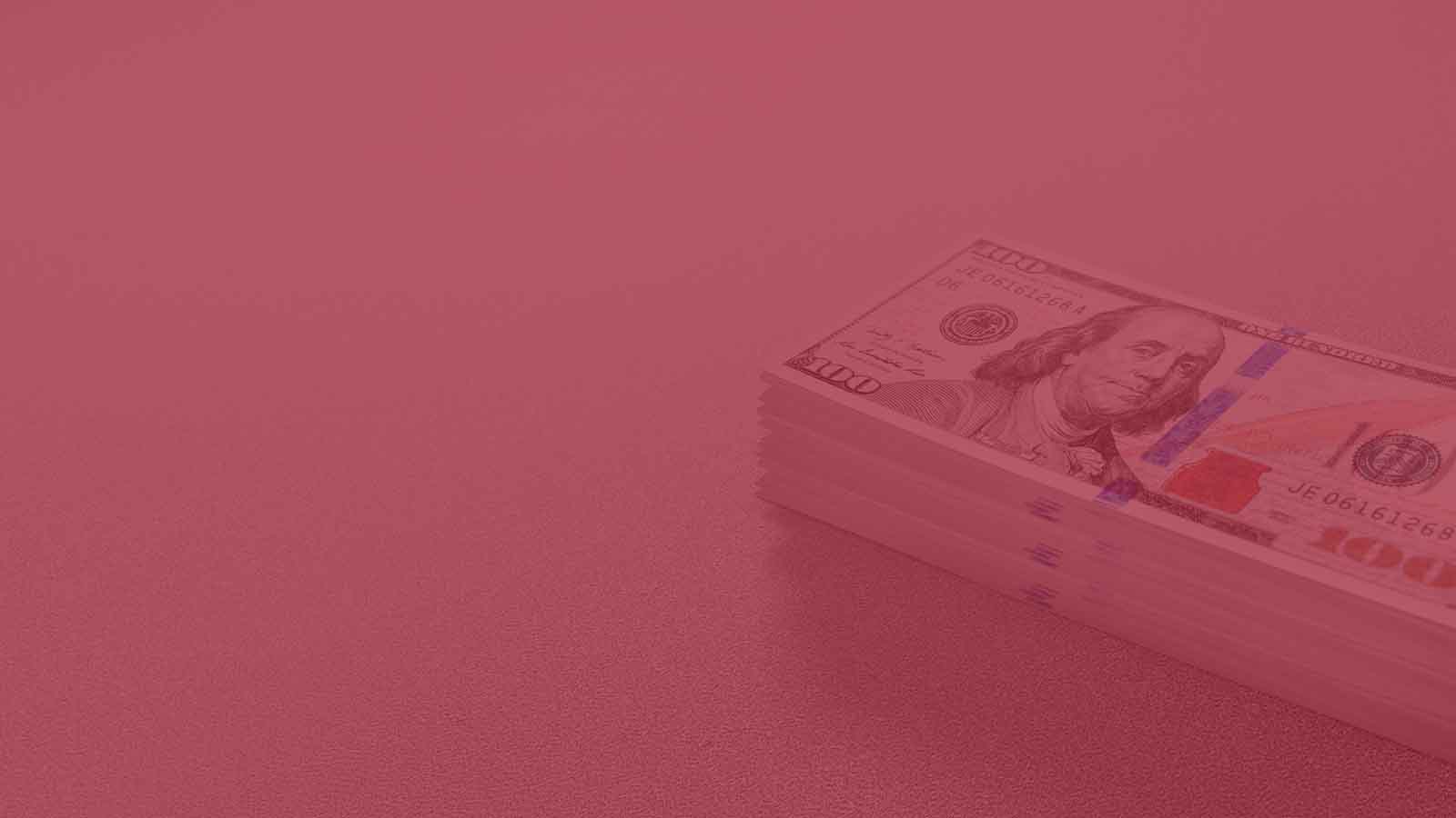 Faded image of a stack of 100 dollar bills