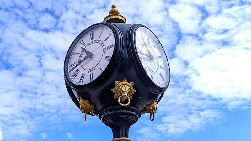 Campus clock with blue sky and clouds in background