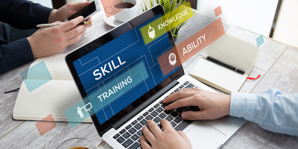 Person typing on a laptop with the words Skill, Training and Ability floating over the screen