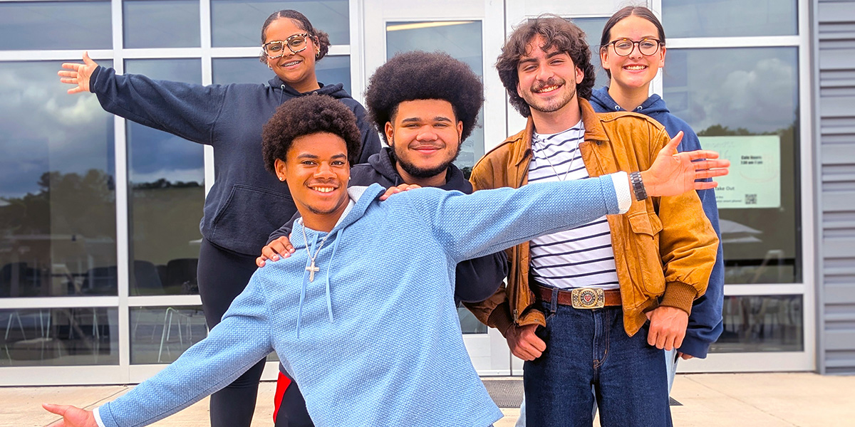 Group of students stand on the steps of the RichmondCC Cafe.