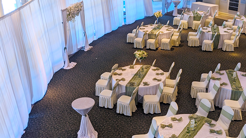 Chairs and tables arranged for a wedding ceremony in the lobby of the Cole