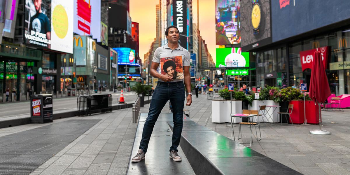 Charl Brown stands with album of Smokey Robinson in NYC