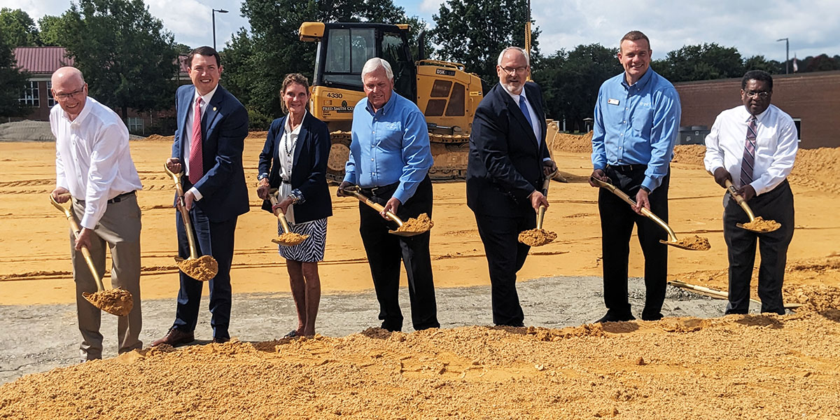 College, community, state and business leaders hold shovels as they break ground on the new Hendrick Center for Automotive Training.