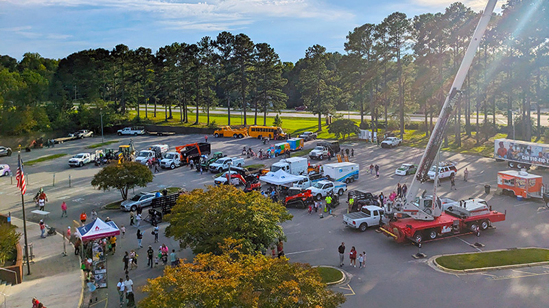 Overview of the Touch-A-Truck event in the Cole Auditorium parking lot