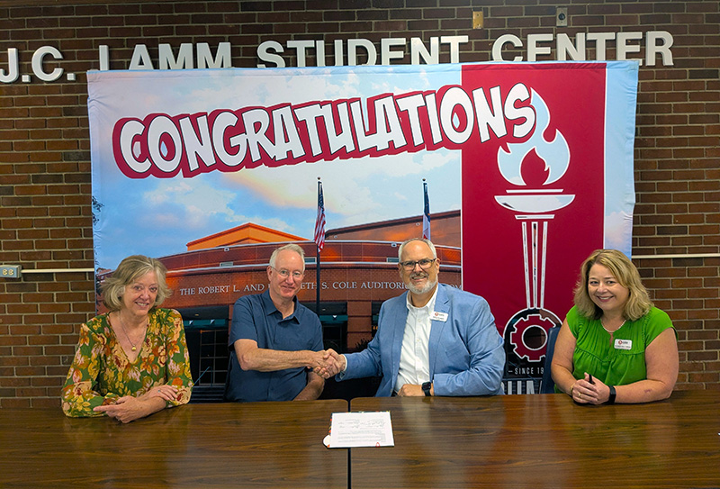J.C. Lamm family members shake hands with College leaders.