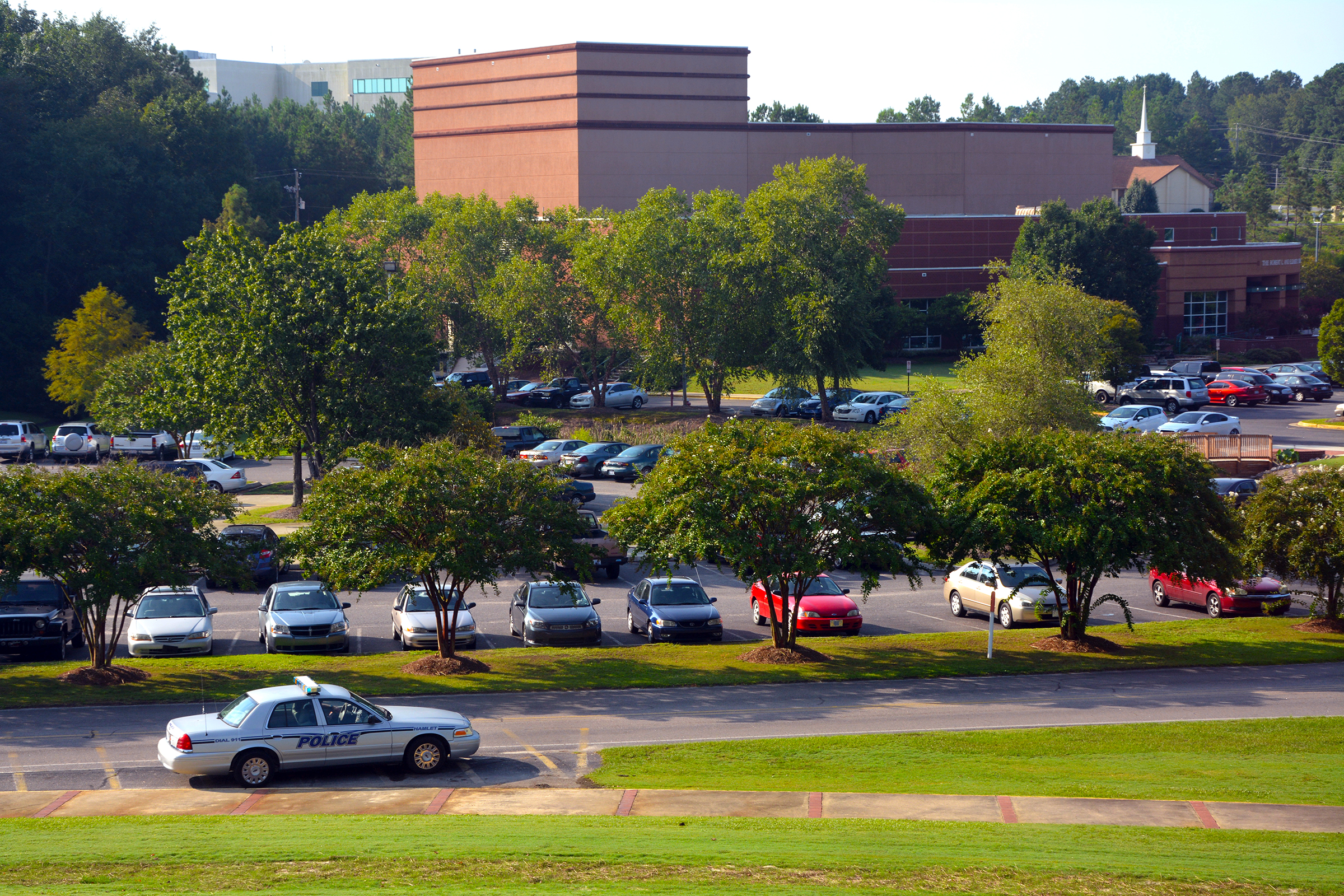 Police car stationed at main road leading onto RCC campus in Hamlet 