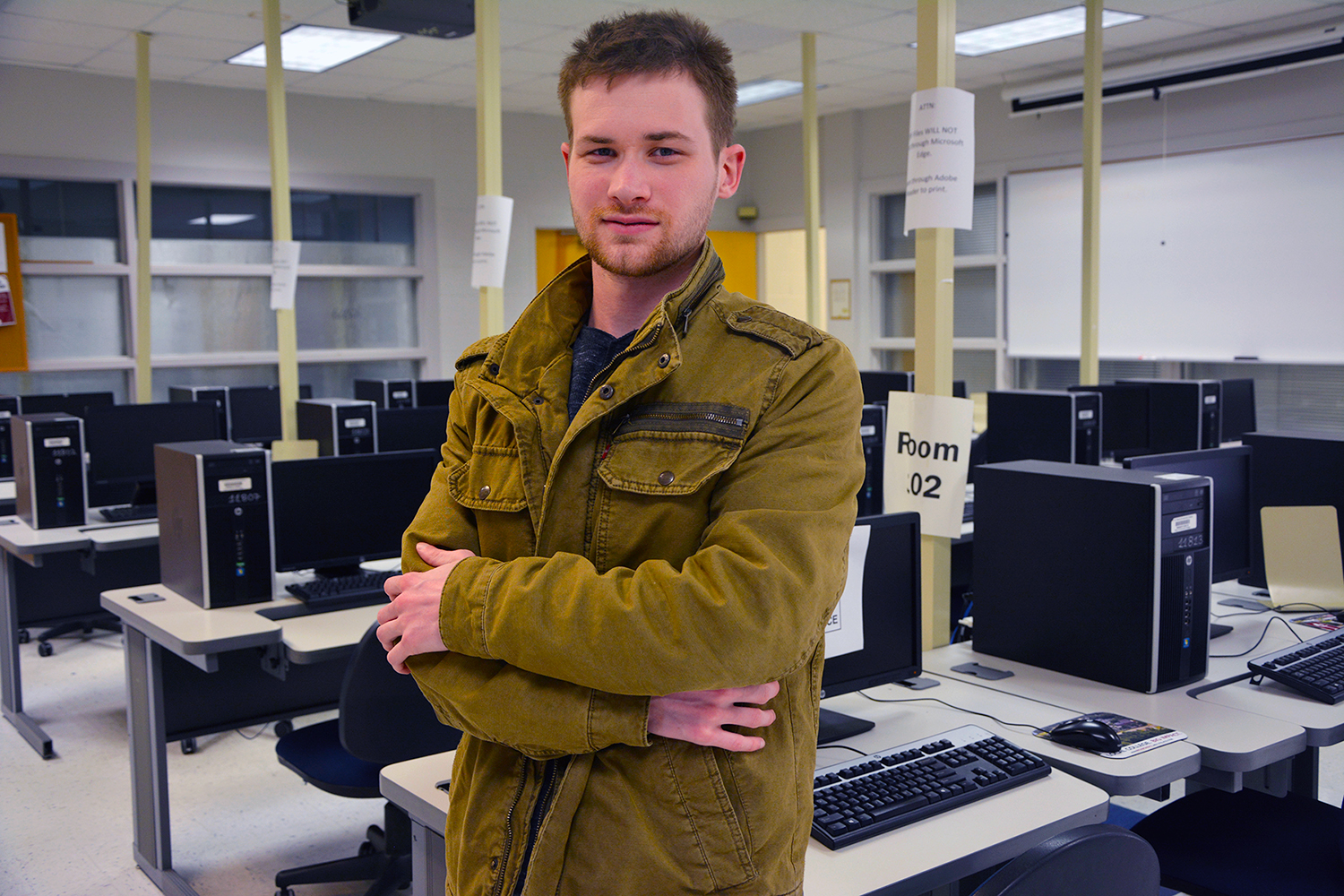 IT student Christian Smith stands in the computer lab in the DeWitt Building.