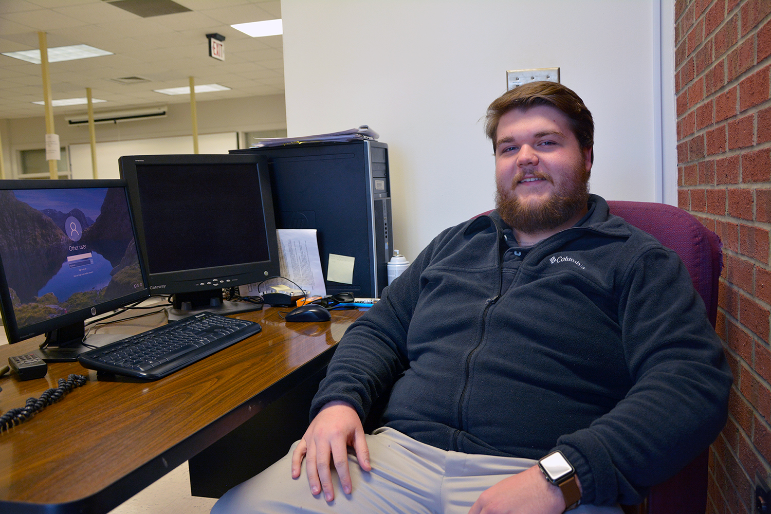 Student campus worker Dylan Liles sits at his computer at the College's Help Desk.